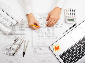 A professional drafting a floor plan of a property